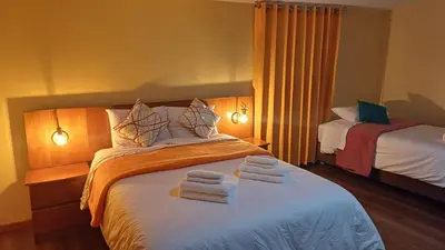 a hotel room with a bed with towels on it at Ecoterra Inka Lodge in Quillabamba