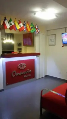 a room with a bar with flags on the wall at Hostal Onassis in Lima