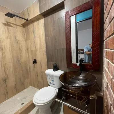 a bathroom with a toilet and a sink at Casa La warida con tres niveles in Ayacucho