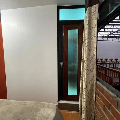 a room with a bed and a window with a door at Casa La warida con tres niveles in Ayacucho