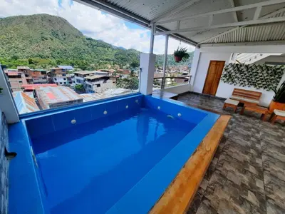 a blue swimming pool on the roof of a house at Hotel Wismont Piñales in La Merced