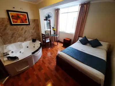 a bedroom with a bed and a bath tub at Hotel Wismont Piñales in La Merced