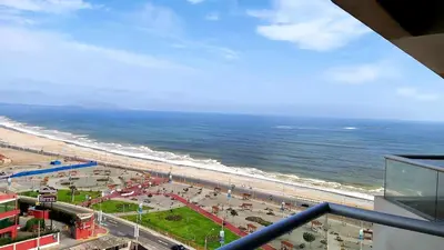 a view of the beach and the ocean from a building at Departamento con Vista al Mar San Miguel in Lima