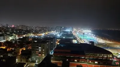 a view of a city at night with the beach at Departamento con Vista al Mar San Miguel in Lima