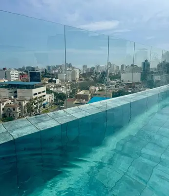 a swimming pool with a view of a city at Rest, comfort and privacy in San Isidro in Lima