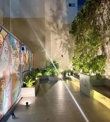a hallway of a building with a painting on the wall at Rest, comfort and privacy in San Isidro in Lima