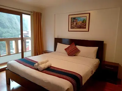 a bedroom with a bed with a stuffed animal on it at El Quetzal MachuPicchu in Machu Picchu