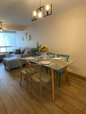 a dining room with a glass table and chairs at Hermoso departamento estreno céntrico in Lima