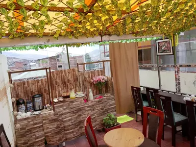 a restaurant with a table and chairs and a bar at INKA's WALK in Cusco