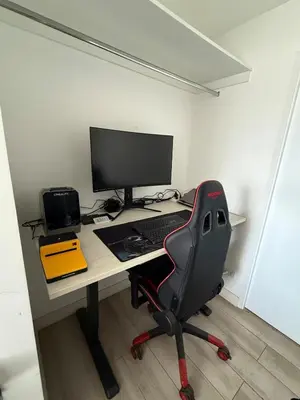 a desk with a computer monitor and a chair at Rest and comfort in San Isidro in Lima