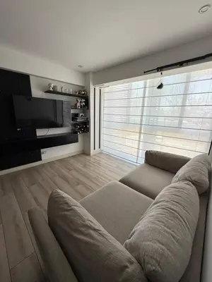 a living room with a couch and a flat screen tv at Rest and comfort in San Isidro in Lima