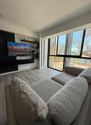 a living room with a couch and a flat screen tv at Rest and comfort in San Isidro in Lima
