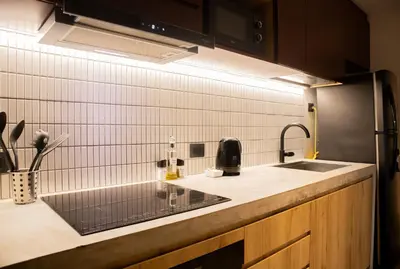 a kitchen with a sink and a refrigerator at Arrieta by Wynwood House in Lima