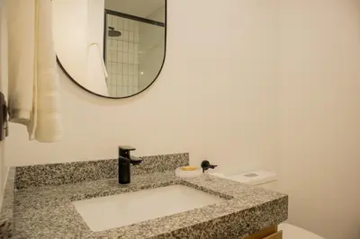 a bathroom with a sink and a mirror at Arrieta by Wynwood House in Lima