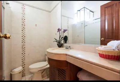a bathroom with a sink and a toilet and a mirror at Apartamento en Miraflores in Lima