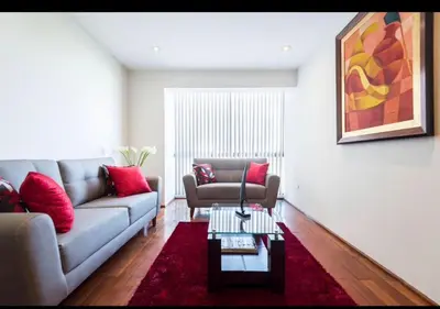 a living room with a couch and a table at Apartamento en Miraflores in Lima