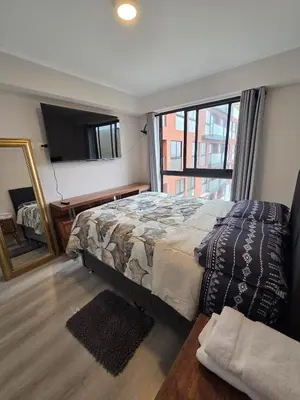 a bedroom with a bed and a large window at Departamento con vista al mar en Lima in Lima