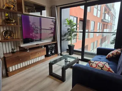 a living room with a large flat screen tv at Departamento con vista al mar en Lima in Lima