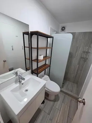 a bathroom with a white sink and a toilet at Departamento con vista al mar en Lima in Lima