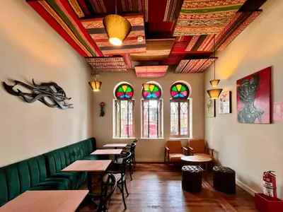 a restaurant with tables and chairs and stained glass windows at Andara Boutique Hotel in Lima