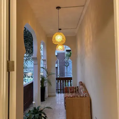 a hallway with a chair and a chandelier at Andara Boutique Hotel in Lima