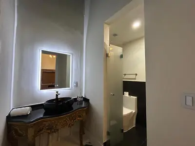 a bathroom with a sink and a mirror and a toilet at Andara Boutique Hotel in Lima