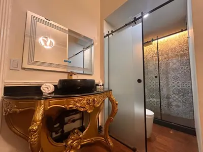 a bathroom with a gold table and a shower at Andara Boutique Hotel in Lima