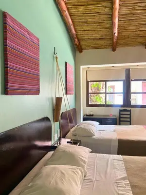 a bedroom with two beds and a window at ViaVia Ayacucho in Ayacucho