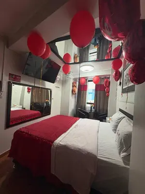 a bedroom with a bed with red balloons on it at Hospedaje Winikunka in Lima