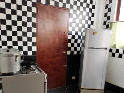a kitchen with a white refrigerator and a stove at Casa del Gringo in Cieneguilla