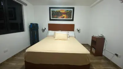 a bedroom with a bed and a dresser in it at Apartamento Tumi Wasi in Lima