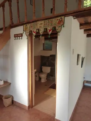 a bathroom with a toilet in a room at Andean Spirit Lodge in Mollepata