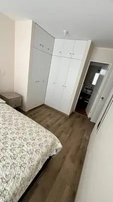 an empty bedroom with a bed and white cabinets at MONTERRICO POLO APARTS #21 - Dpto 2 Dorm Frente Embajada de USA in Lima