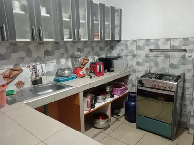 a kitchen with a sink and a stove at Casa de campo juana brymarme in Chosica