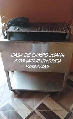 a sign on the side of a grill with writing on it at Casa de campo juana brymarme in Chosica