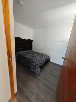 a bedroom with a bed in the corner of a room at Habitacion con Cochera in Atico