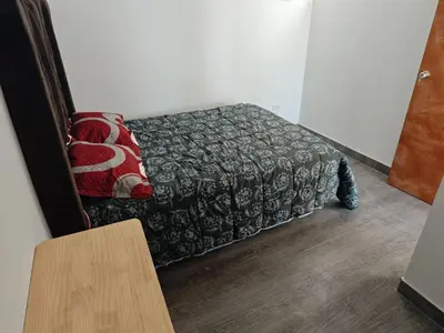 a room with a bed with a blanket and a table at Habitacion con Cochera in Atico