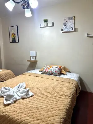 a bedroom with two beds with towels on them at Galicia Lodgement in Lima
