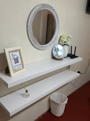 a white shelf with a mirror on a wall at Galicia Lodgement in Lima