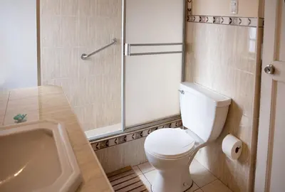 a bathroom with a toilet and a sink and a shower at The film House in Lima