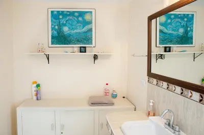 a bathroom with a sink and a mirror at The film House in Lima