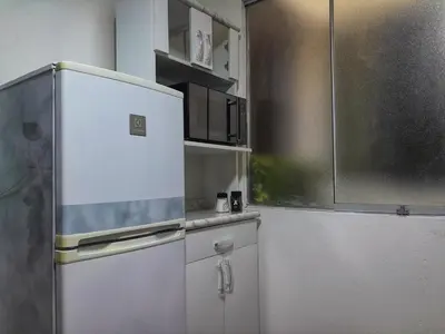 a kitchen with a white refrigerator in a room at Cozy Apartment for Tourist in Lima