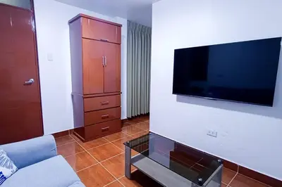 a living room with a flat screen tv on a wall at Cozy Apartment for Tourist in Lima