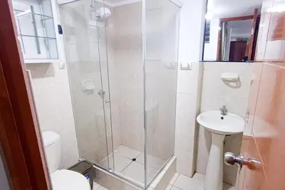 a bathroom with a shower with a toilet and a sink at Cozy Apartment for Tourist in Lima