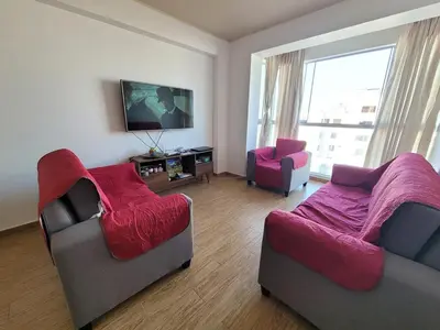 a living room with two couches and a tv at 1cuarto 2 camas baño privado in Lima