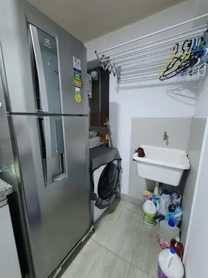 a small kitchen with a refrigerator and a sink at 1cuarto 2 camas baño privado in Lima