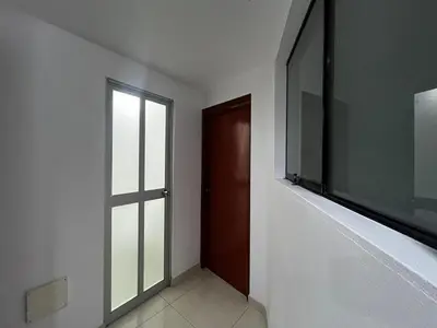 an empty hallway with a door and a window at Departamento Centro Histórico in Ayacucho