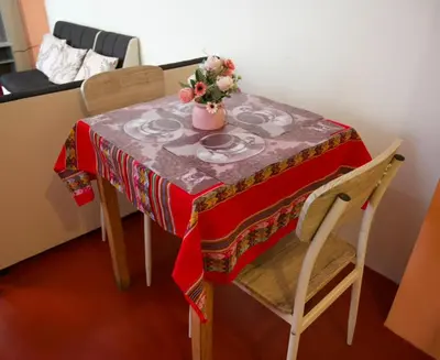 a table with a vase of flowers on it at Casa Secretos in Cusco