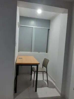 a table and chair in a room with a window at Casa El Valle de Lunahuaná in Lunahuaná