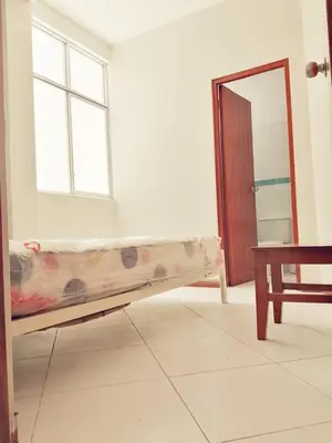 a bed in a room with a window and a mirror at Apartamento en Ayacucho in Ayacucho